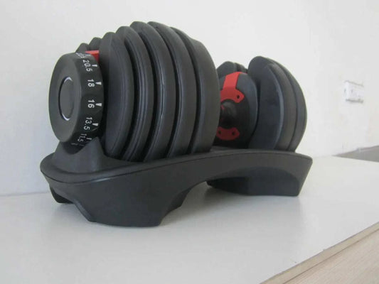 24KG adjustable dumbbell with black rubber-coated weight plates on a black plastic stand for home fitness and weightlifting