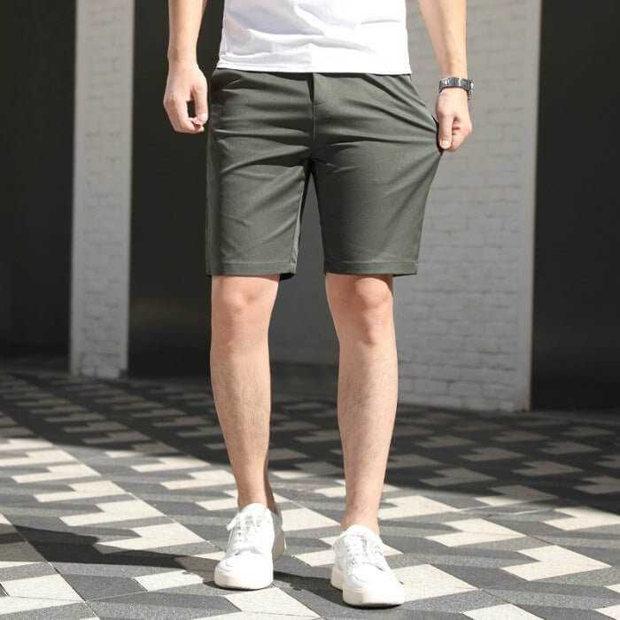 Men's casual loose fit summer pants in army green with elastic waistband and white sneakers