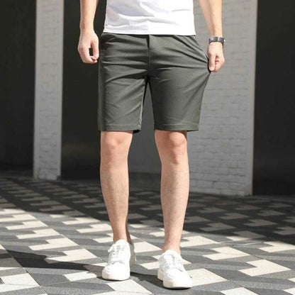 Men's casual loose fit summer pants in army green with elastic waistband and white sneakers
