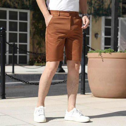 Men's brown casual summer pants with elastic waist and white sneakers outdoors