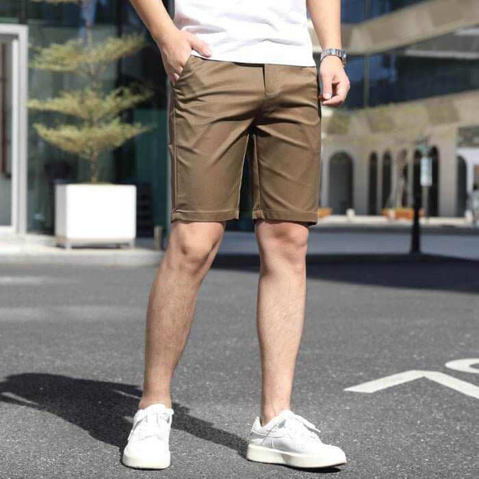 Men's casual brown summer pants with elastic waistband, styled with white sneakers and a white t-shirt outdoors.