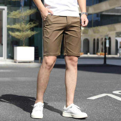 Men's casual brown summer pants with elastic waistband, styled with white sneakers and a white t-shirt outdoors.