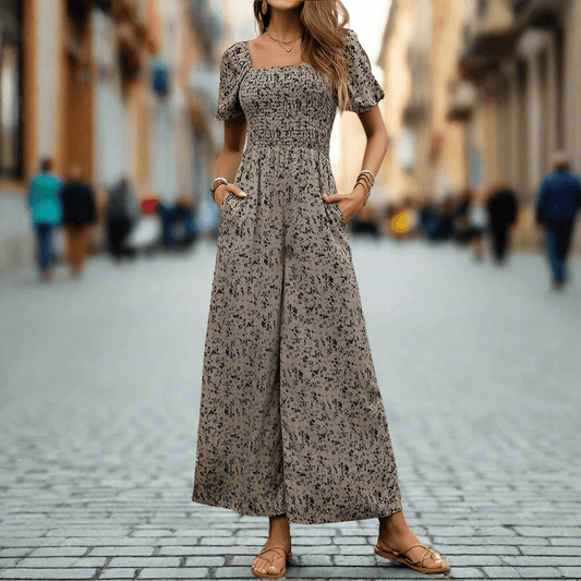 Woman wearing fashionable wide-leg printed jumpsuit with short puff sleeves on city street