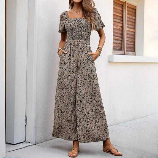 Woman wearing apricot printed wide-leg pants jumpsuit with puff sleeves and smocked bodice standing outdoors