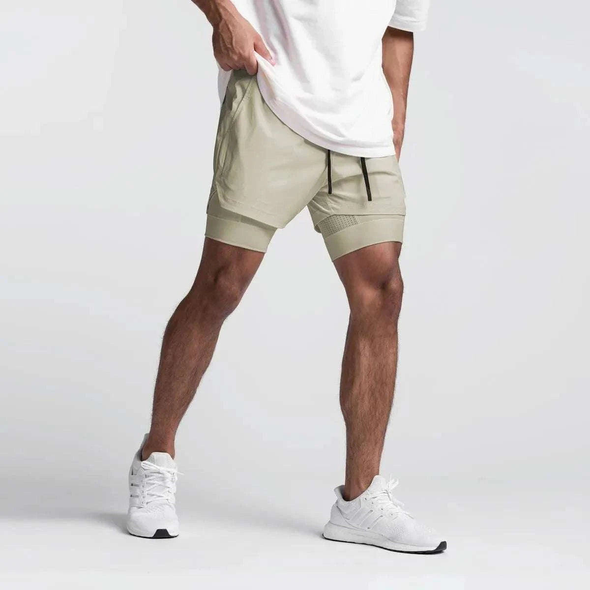 Men wearing beige 2 in 1 fitness gym shorts with towel loop and breathable mesh inner tights.