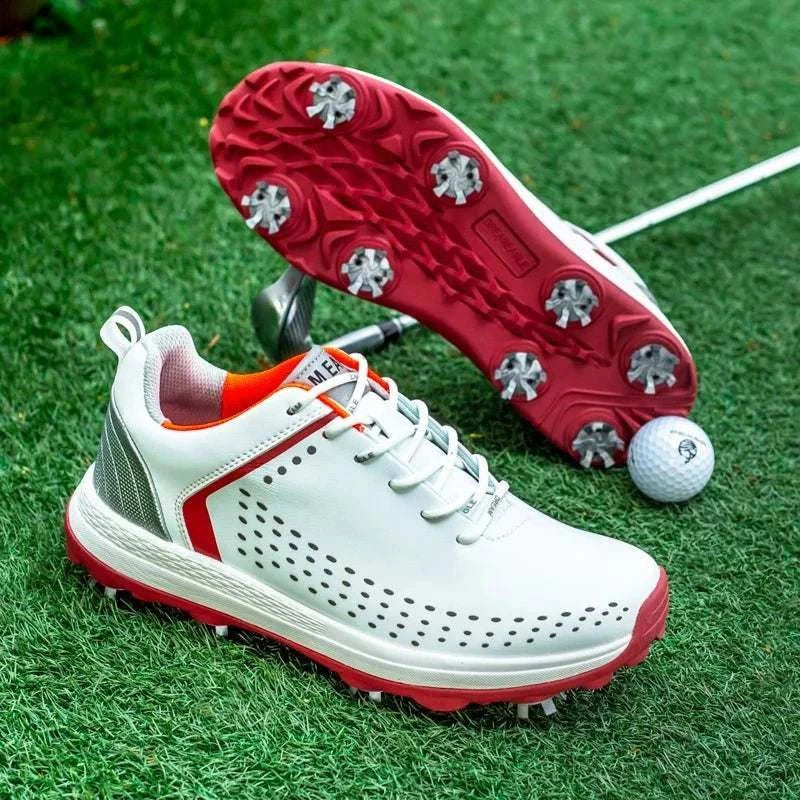 Microfiber leather golf shoes for men with non-slip red soles and rotation shoelace system on green turf next to golf ball and club
